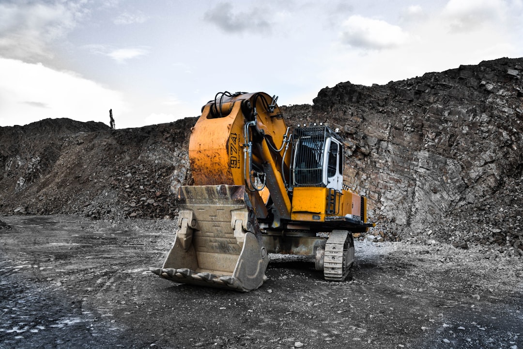 yellow-and-black-excavator-near-hill-1je5j4an2ri